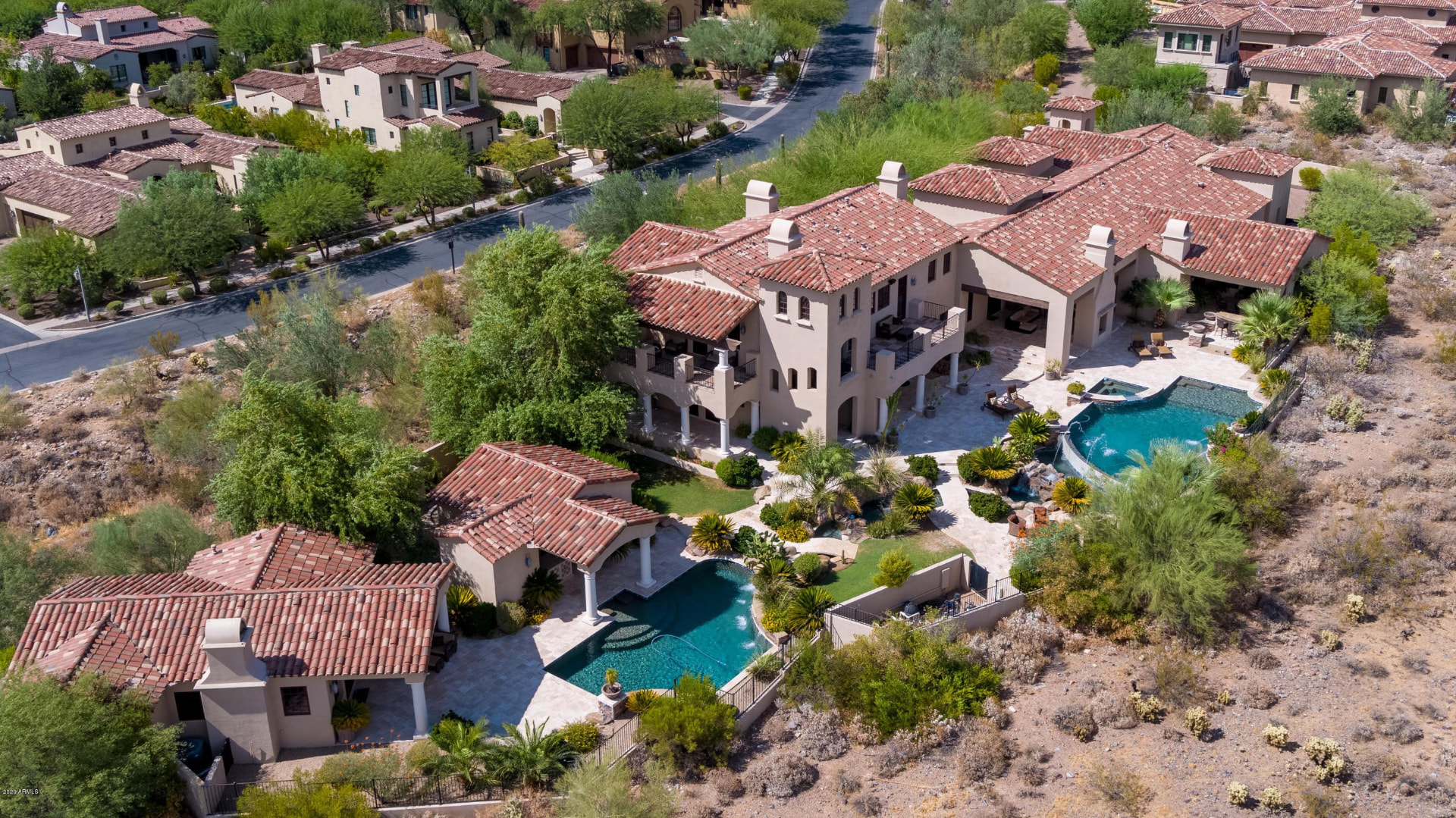 Aerial view of a custom home with resort-style pool and outdoor living