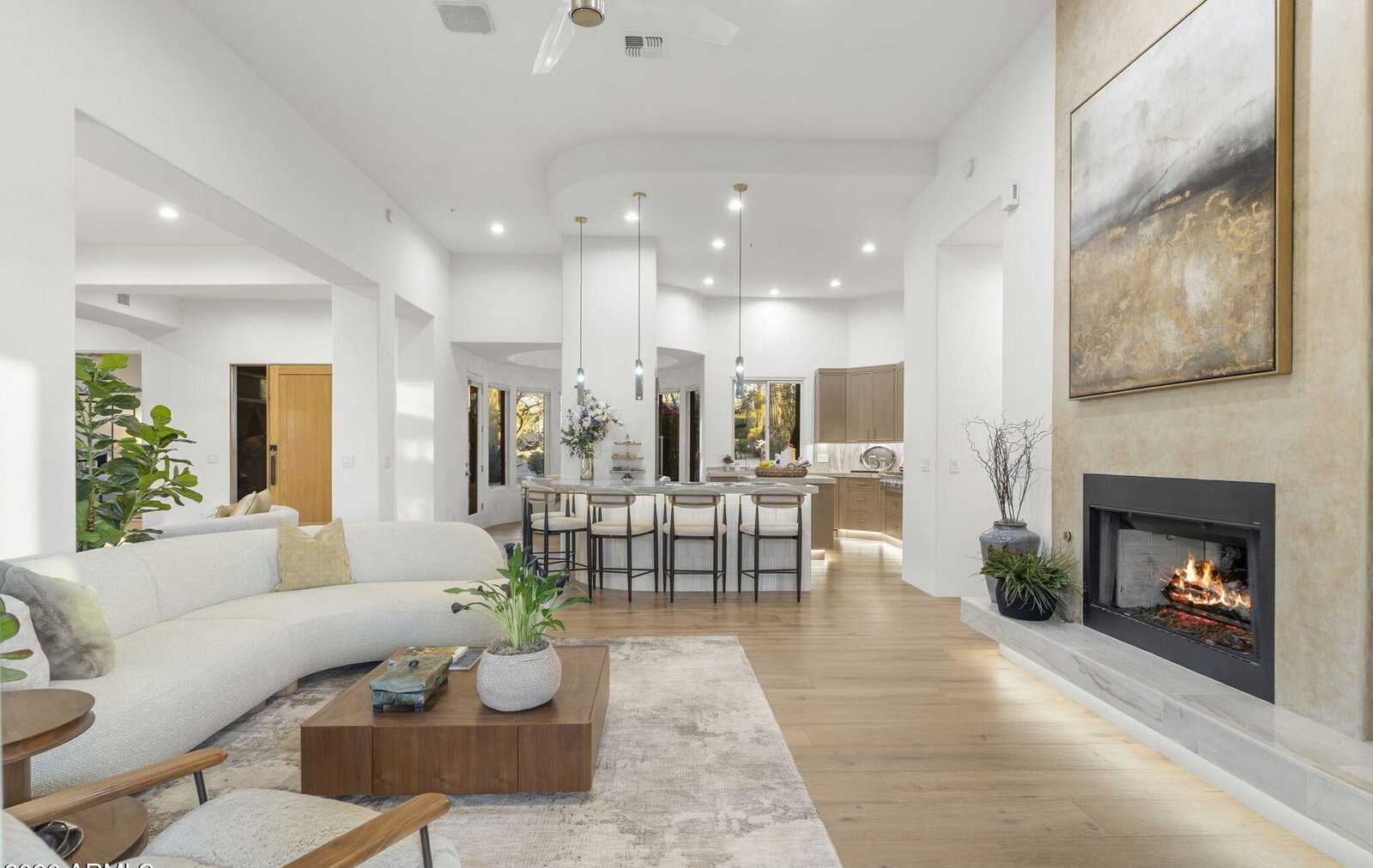 Great room with a floor-to-ceiling stone fireplace and desert views